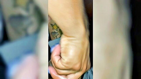 Tattooed arm gripping in intense car blowjob scene