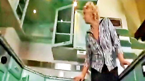 Blonde granny cougar milf in patterned blouse on stairs