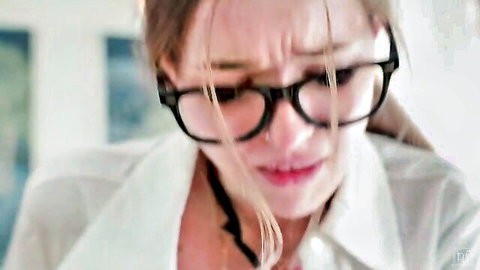 Olivia Sparkle emotional closeup in white shirt and glasses, NubileFilms spanking scene