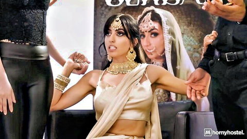 Sexy Indian babe in sheer saree blouse showing cleavage with arms held high by group