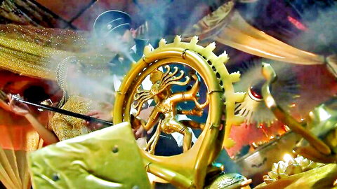 Vibrant cultural dance with golden Shiva Nataraja statue and performers in elaborate costumes