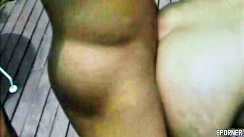 Closeup of woman's bare ass cheeks and pussy exposed outdoors on wooden deck