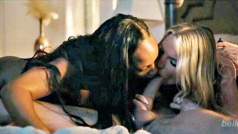 Ebony beauty passionately French kissing busty blonde's exposed tits on bed