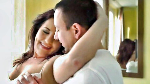 Red Mary smiling as Rob embraces her from behind in intimate hairy erotica hug
