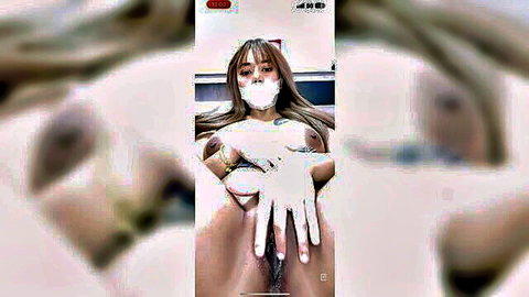 Asian woman in white mask and latex gloves spreads pussy close-up