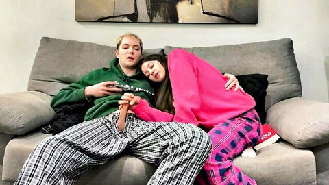 Step brother and sister cuddle on couch in pajamas, teasing handjob vibe