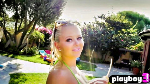 Blonde babe in skimpy green bikini posing by pool, Playboy outdoor tease