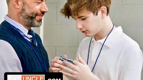 Bearded DILF teacher showing Rubik's cube to young ginger twink student in gay scene