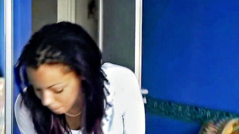 Sexy ebony teen with purple braids in tight white top looking down seductively