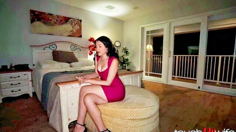 Ruby Moon in tight red dress, seductive pose on Touch My Wife video