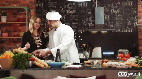 Blonde babe in sexy lace top flirts with chef chopping veggies in kitchen