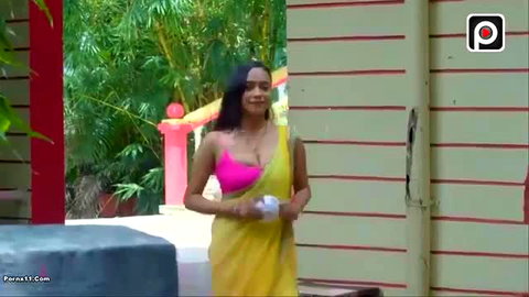 Desi Indian babe in sheer yellow saree pink blouse teasing outdoors