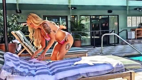 Busty blonde Sarah Harlow in pink bikini by pool