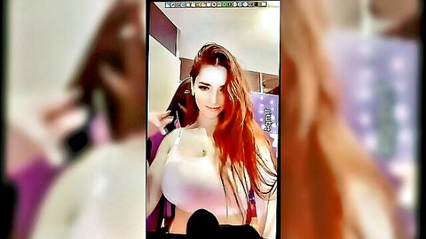Seductive redhead Angel Bigo in white bra showing big cleavage