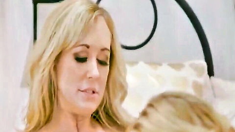 Two blonde babes passionately kissing and licking necks in steamy lesbian bedroom encounter