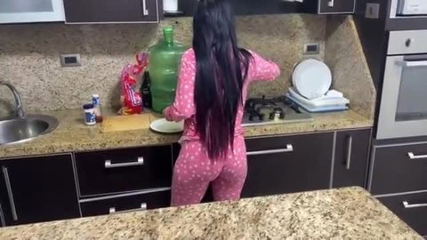 Brunette teen in tight pink polka-dot pajamas cooking, big ass view
