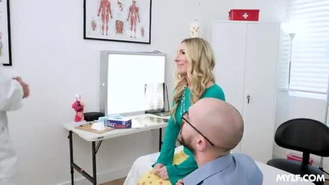 Blonde patient gets eaten out by doctor while legs spread on exam table