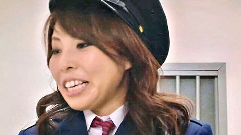 Smiling Japanese woman in prison guard uniform with hat and tie