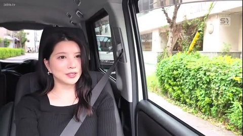 Nagi Hikaru smiling in car seat, black top, JAV thumbnail