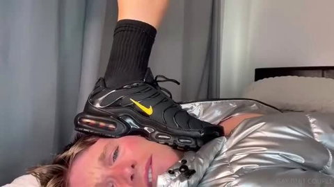 Hot girl in black Nike TNs and socks stands on guy's face in shiny puffer jacket