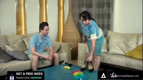 Nikki Nuttz as hot granny maid in blue outfit seducing employer in living room