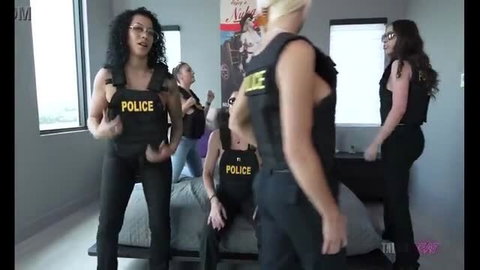 Cory Chase with four women in police vests, group roleplay scene