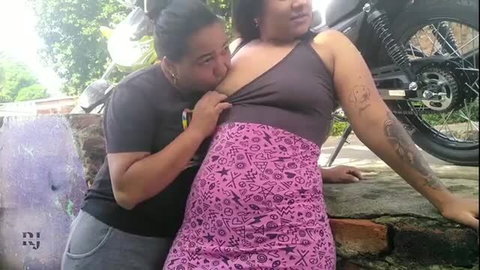 Latina woman in pink skirt gets breast sucked outdoors