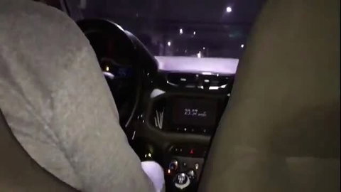 Nighttime car interior POV with dashboard display showing speed