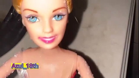 Blonde doll face close-up with blue eyes and pink lips