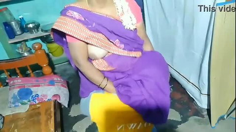 Indian auntie in purple sari exposing breast while cleaning
