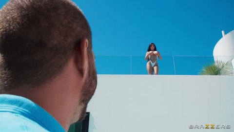 Sara Retali in white bikini posing on balcony rooftop under blue sky