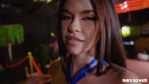Rossa Vax in yellow outfit at strip club, close-up face and tattoo
