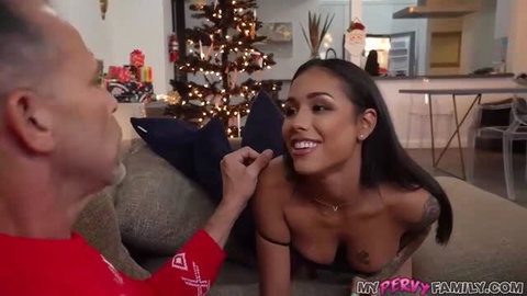 Camila Cortez topless with Armani Black on couch during Christmas scene