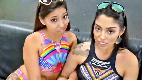 Two sexy Latina sisters in colorful bikinis, teasing together