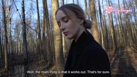 Polly Yangs in black coat outdoors in forest park