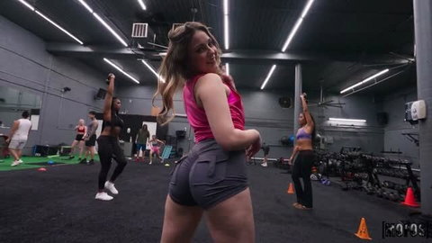 Violet Dawn in pink crop top and grey booty shorts at gym