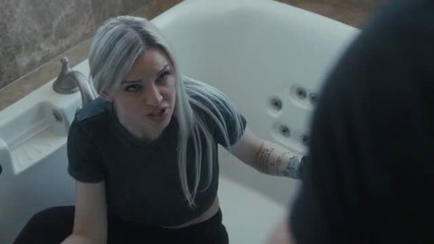 Kenzie Taylor in bathtub wearing black crop top and leggings