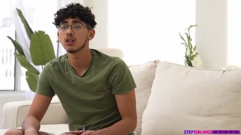 Layla Jenner in green shirt talking on couch
