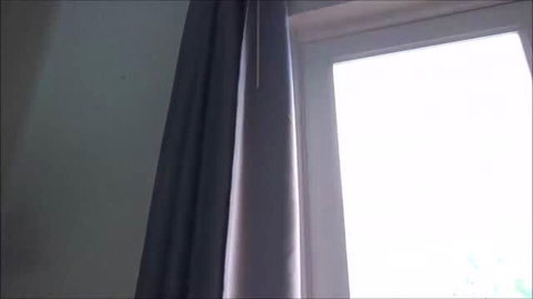 Shay Evans in sheer curtain light by window
