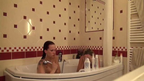 Leila Smith and Leony Aprill lesbian bath scene with oily massage