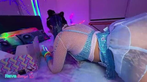 Penelope Woods in fishnets and blue lingerie showing anal plug on bed
