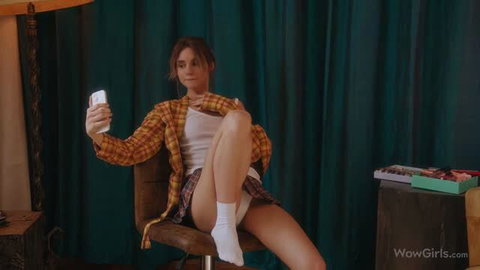 Mia Bloom in plaid shirt taking selfie, white panties visible