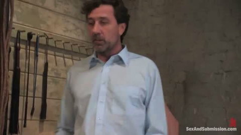 Steve Holmes in blue shirt in BDSM dungeon, Sex And Submission