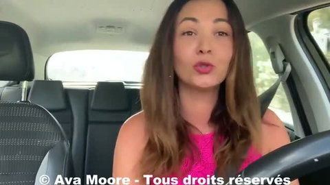 Ava Moore in pink top driving car, talking to camera