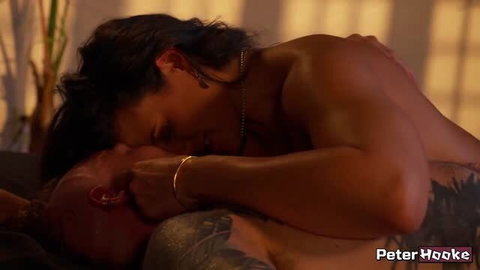 Penny Barber sensual lesbian scene with tattooed partner in warm lighting