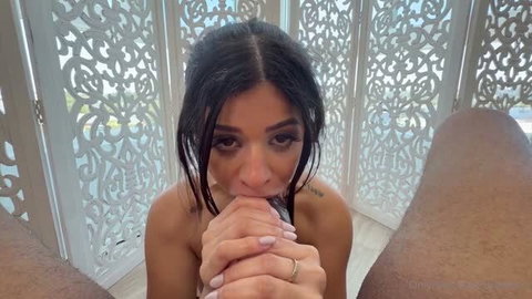Brunette Latina giving interracial blowjob with hands clasped
