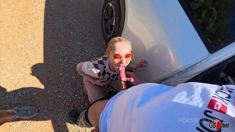 Blonde teen girl in checkered top gives outdoor blowjob to older man near white car