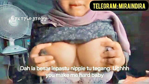 Malay woman in hijab exposing and squeezing large breasts
