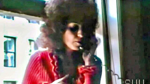 Sharon Mitchell on phone in red frilly sweater, intense gaze, 1977 vintage porn